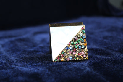 1940s gold-tone compact with mother-of-pearl lid and multicolored rhinestones.