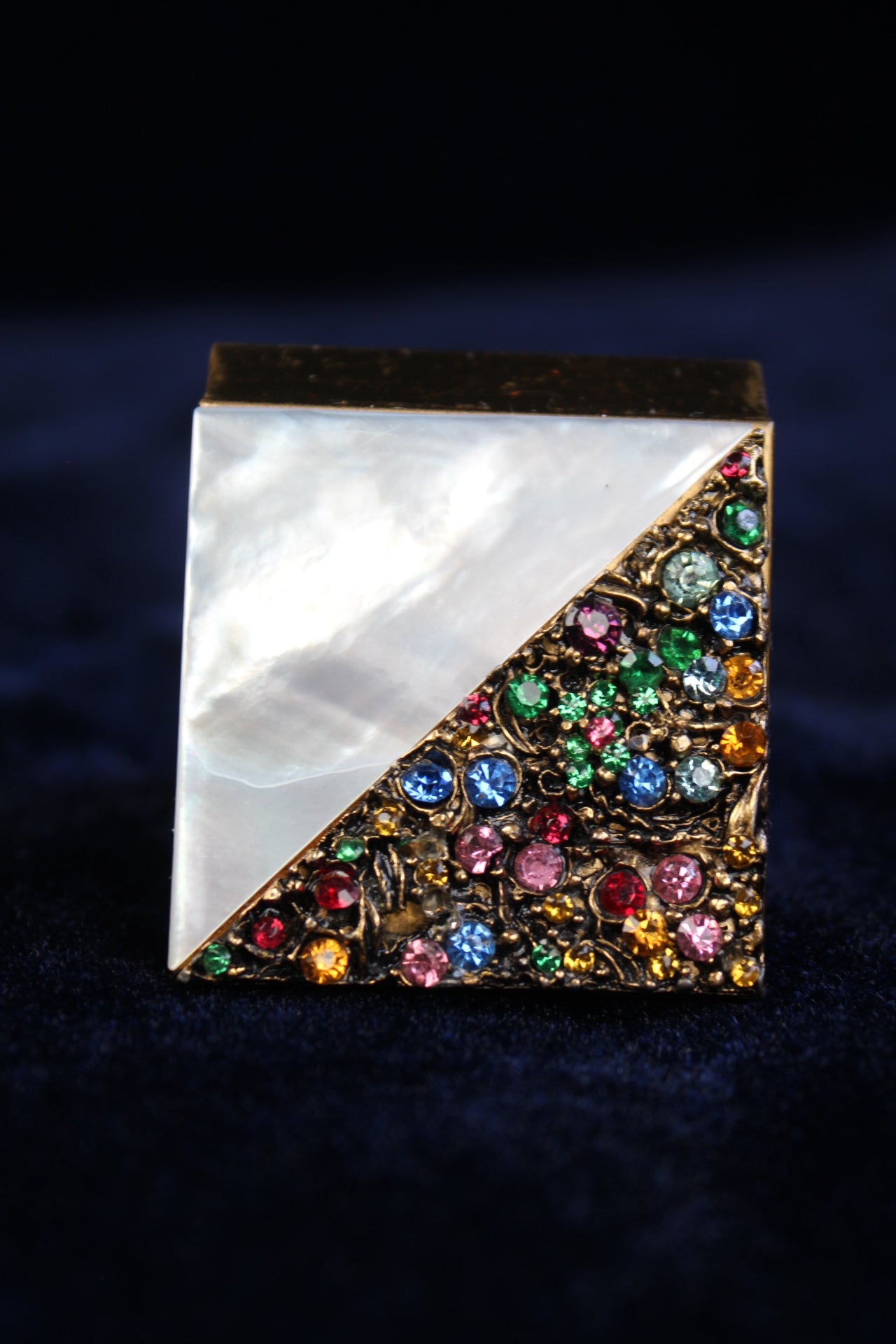 1940s compact with mother-of-pearl and gold filigree with colorful rhinestones.