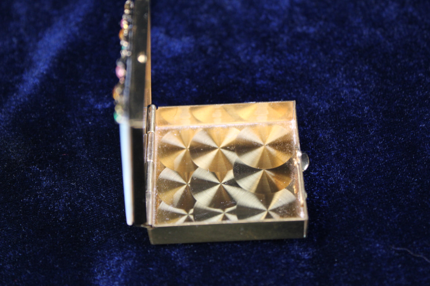 1940s gold filigree powder compact with mother of pearl lid and rhinestones.