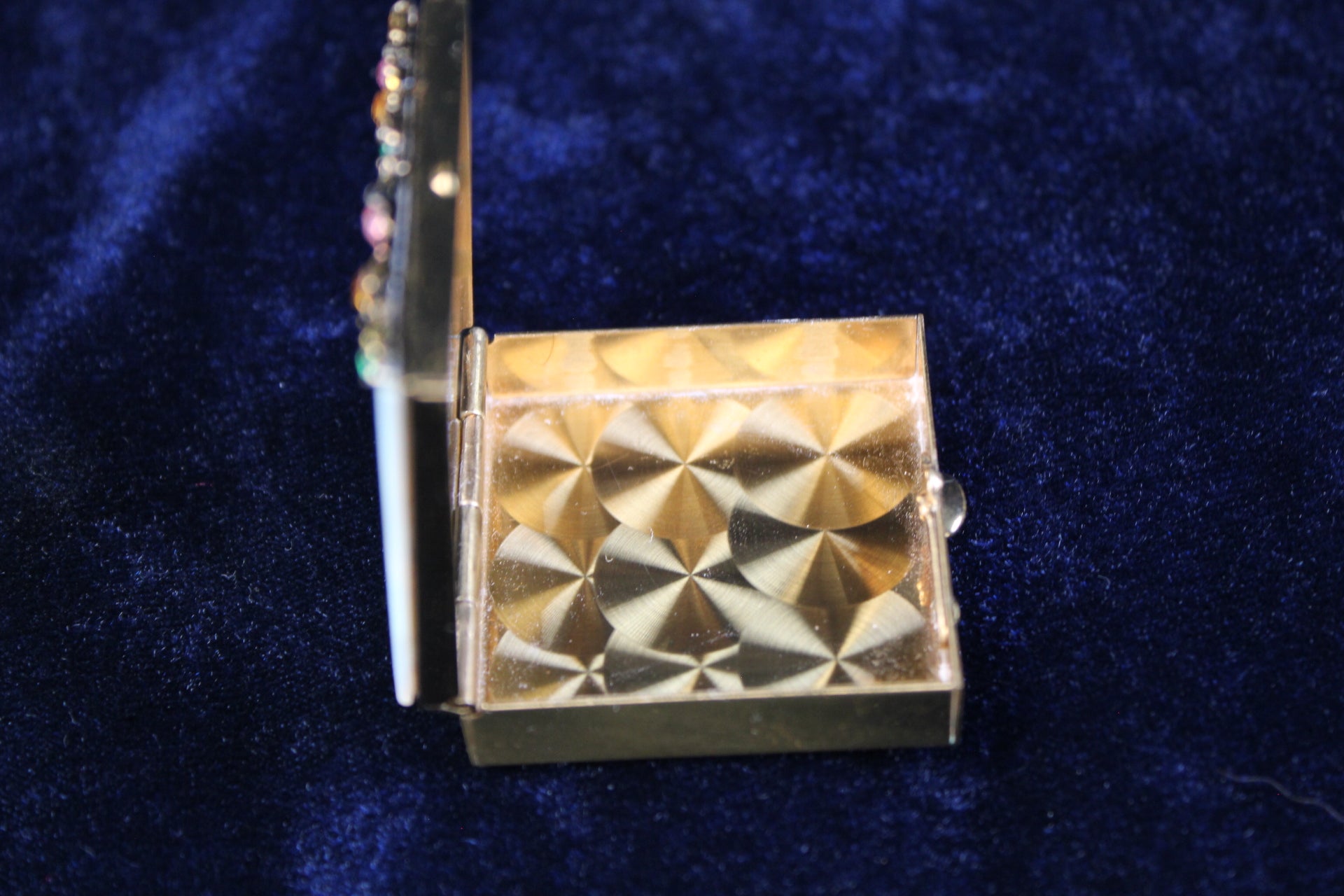 1940s gold filigree powder compact with mother of pearl lid and rhinestones.